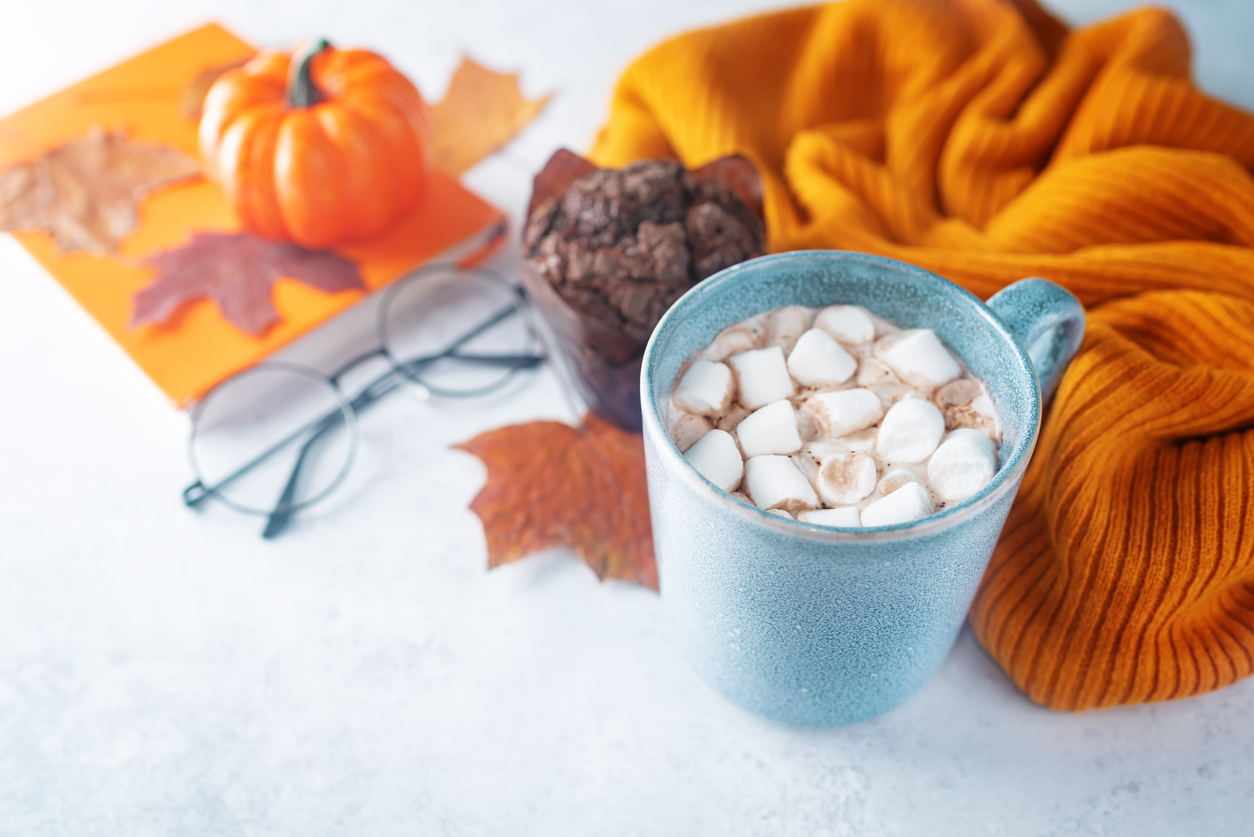 Hot chocolate, blanket, glasses, and pumpkin